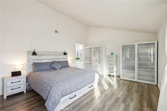 bedroom with lofted ceiling and hardwood / wood-style floors