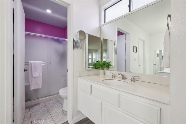 full bath featuring tile patterned floors, a shower stall, toilet, and vanity