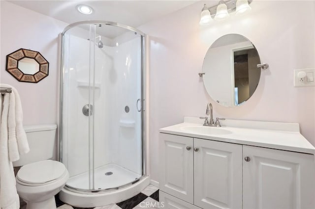 full bath with vanity, toilet, and a shower stall