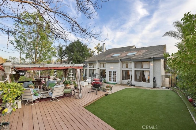 back of house featuring a wooden deck, a pergola, stucco siding, french doors, and a lawn