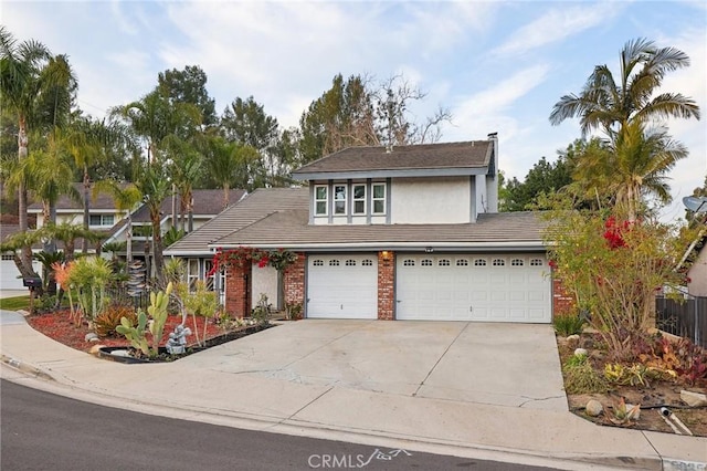 view of front of house with brick siding, stucco siding, and driveway