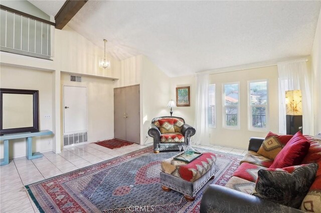 tiled living room with beam ceiling, a chandelier, and high vaulted ceiling