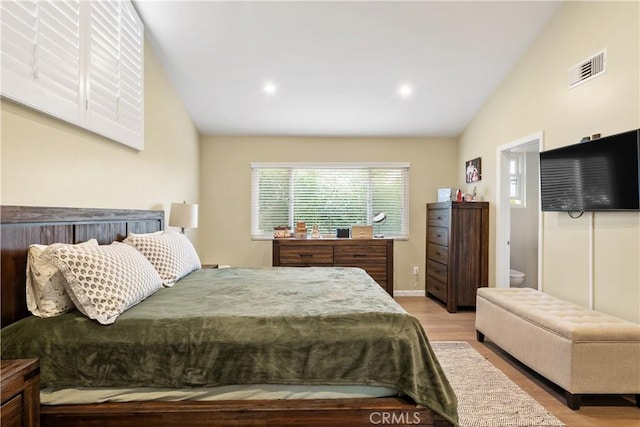 bedroom featuring recessed lighting, wood finished floors, visible vents, baseboards, and vaulted ceiling