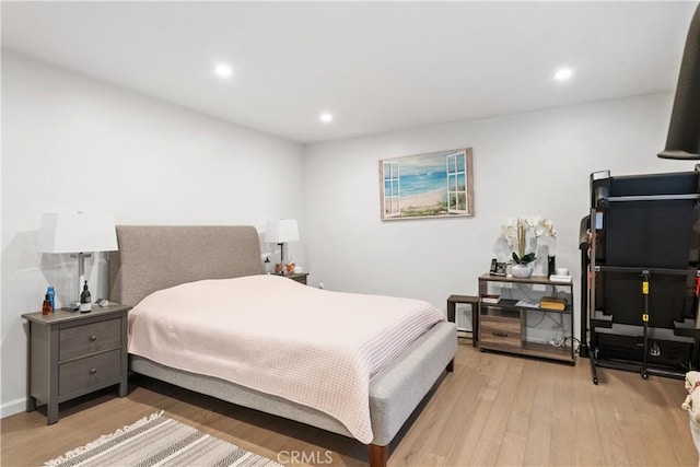 bedroom with light wood-style floors and recessed lighting