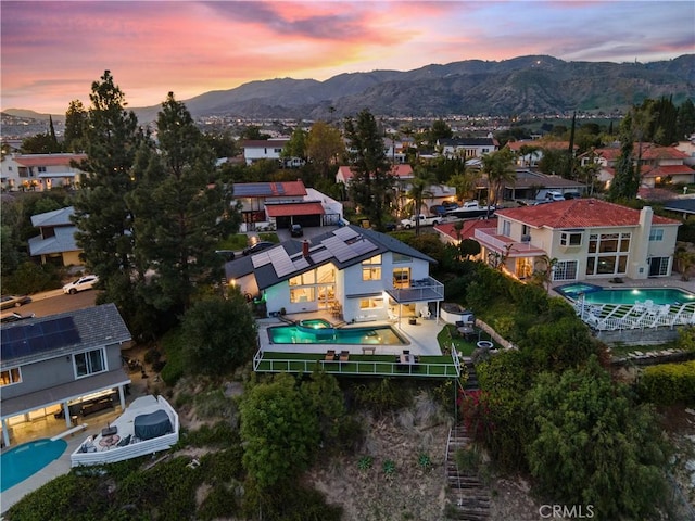 aerial view at dusk with a residential view and a mountain view