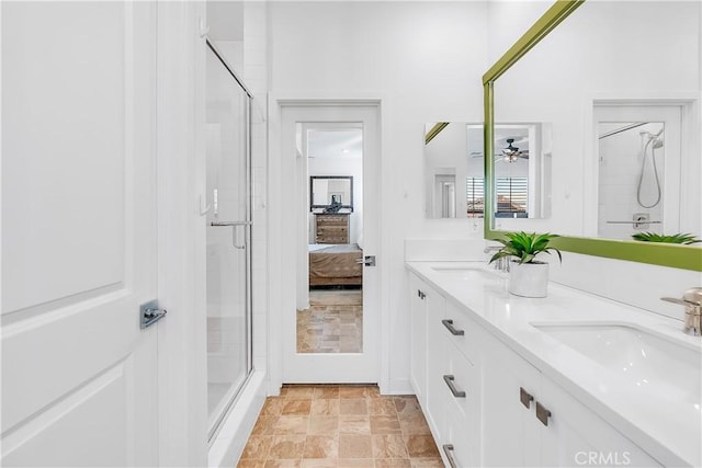 bathroom with vanity and a shower with shower door