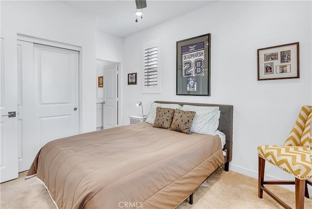 carpeted bedroom featuring ceiling fan and a closet