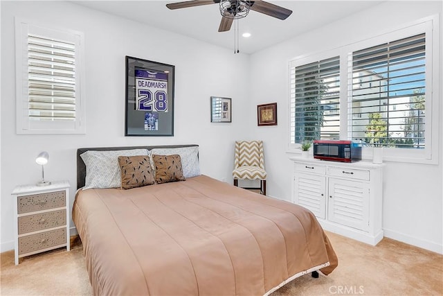 bedroom with ceiling fan and light colored carpet