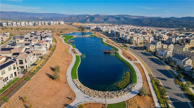 birds eye view of property with a water and mountain view