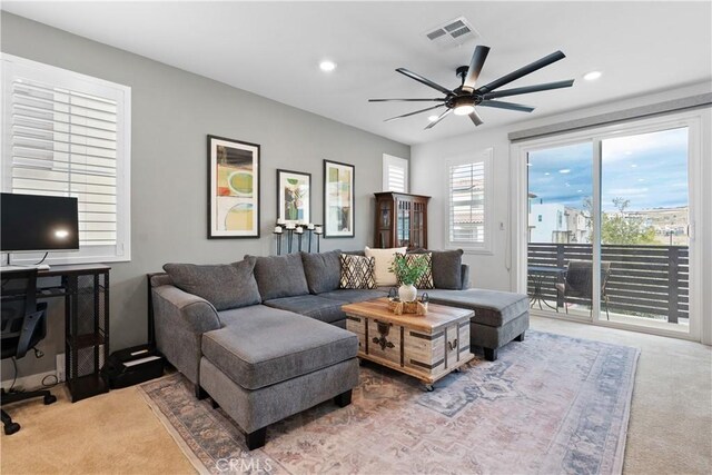 living room with ceiling fan and carpet floors