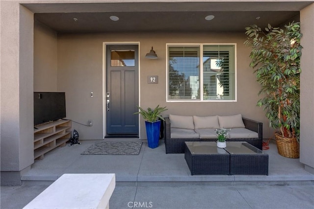 property entrance with outdoor lounge area and a patio