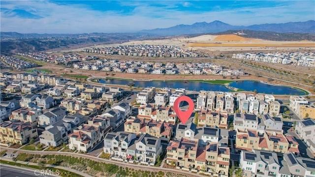 birds eye view of property featuring a water and mountain view