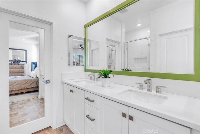 bathroom featuring vanity, a shower with shower door, and ceiling fan