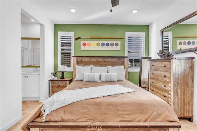 bedroom with sink and light carpet