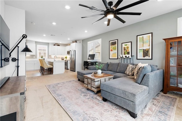 living room featuring sink and ceiling fan