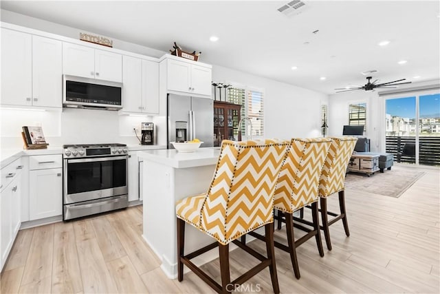92 Juniper Dr, Rancho Mission Viejo, CA 92694 - kitchen with visible vents, light wood-style flooring, appliances with stainless steel finishes, and recessed lighting