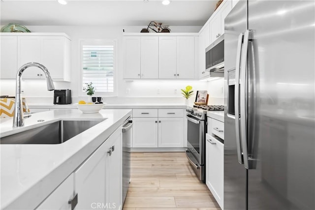 92 Juniper Dr, Rancho Mission Viejo, CA 92694 - kitchen featuring stainless steel appliances, light countertops, white cabinetry, and a sink
