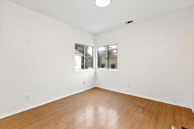 spare room with hardwood / wood-style flooring