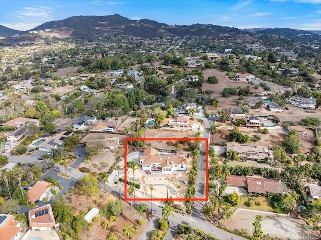 birds eye view of property featuring a mountain view