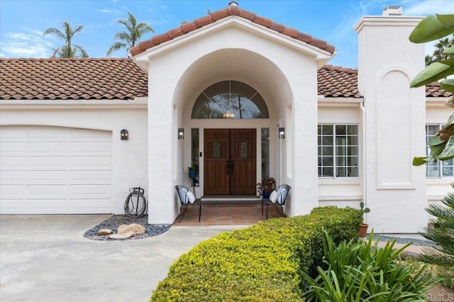 view of exterior entry with a garage