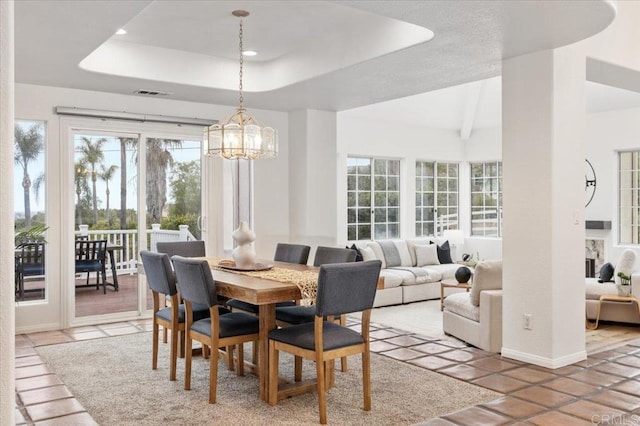 dining space featuring a chandelier and a tray ceiling