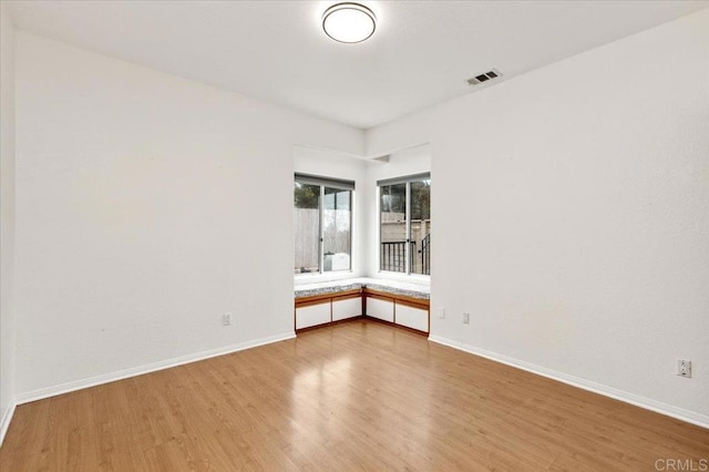 spare room featuring hardwood / wood-style floors