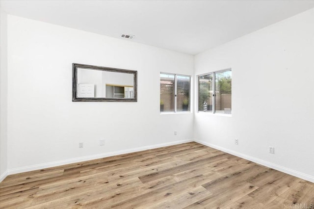 unfurnished room with light hardwood / wood-style flooring