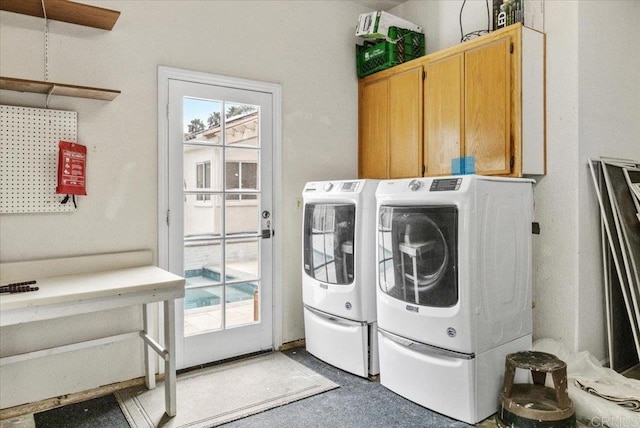 washroom with separate washer and dryer, a wealth of natural light, and cabinets