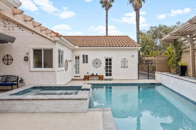 view of pool with an in ground hot tub, pool water feature, and a patio area