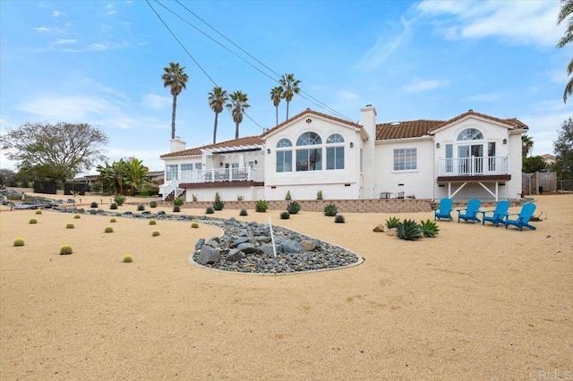 back of property featuring a balcony