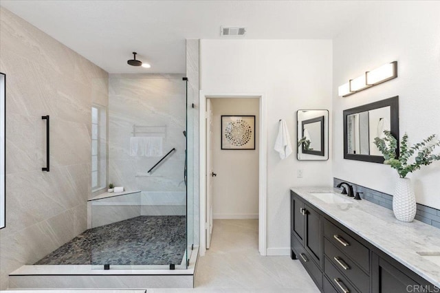 bathroom featuring vanity and a tile shower