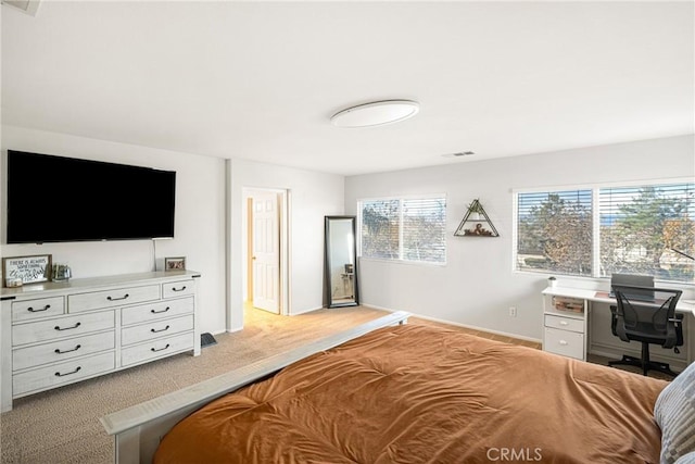 bedroom with light carpet, visible vents, and baseboards