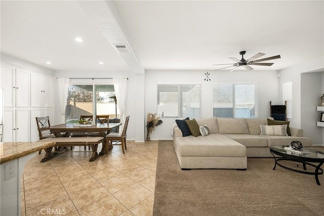 living room featuring light tile patterned floors, recessed lighting, visible vents, a ceiling fan, and baseboards