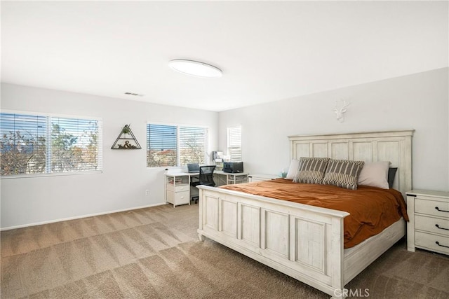 bedroom with baseboards, visible vents, and light colored carpet