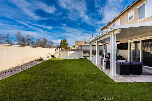 view of yard with a fenced in pool, an outdoor living space, a patio area, and a fenced backyard