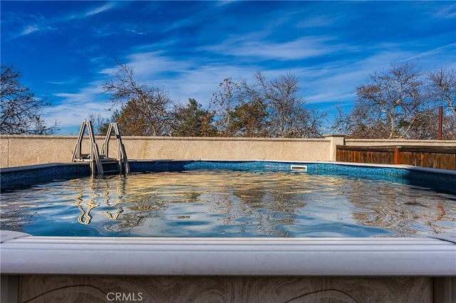 view of swimming pool with a fenced in pool and fence