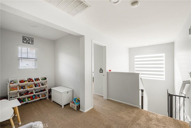 game room featuring visible vents, light carpet, and baseboards