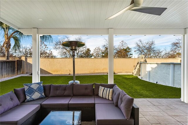 view of patio / terrace with ceiling fan, an outdoor living space, and a swimming pool