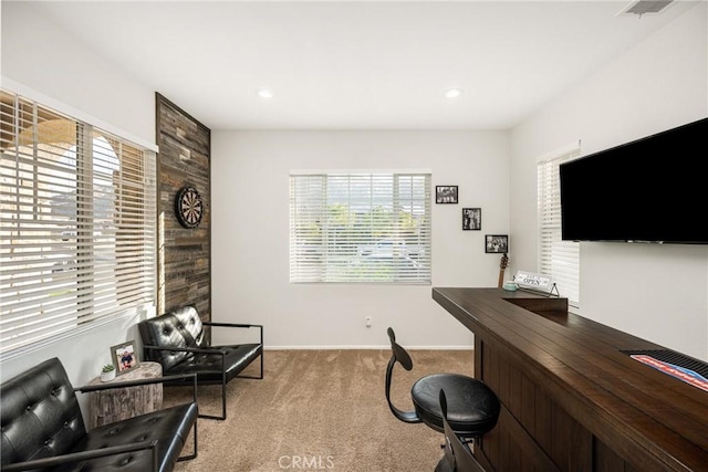 office with baseboards, a healthy amount of sunlight, visible vents, and light colored carpet