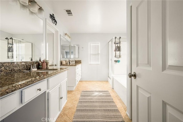 bathroom featuring vanity, plus walk in shower, and tile patterned flooring