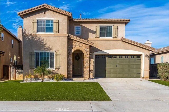 view of front of property featuring a garage and a front yard