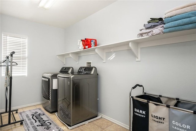 washroom with laundry area, washer and clothes dryer, and baseboards