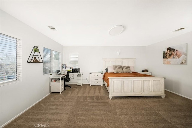 bedroom featuring baseboards, visible vents, and dark colored carpet