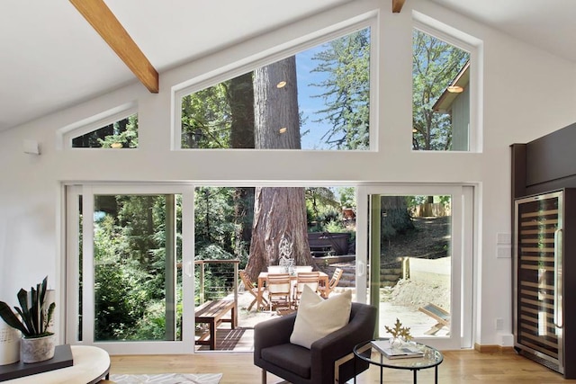 interior space featuring lofted ceiling with beams and wine cooler