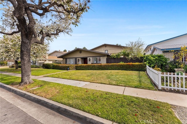 ranch-style house with a front lawn