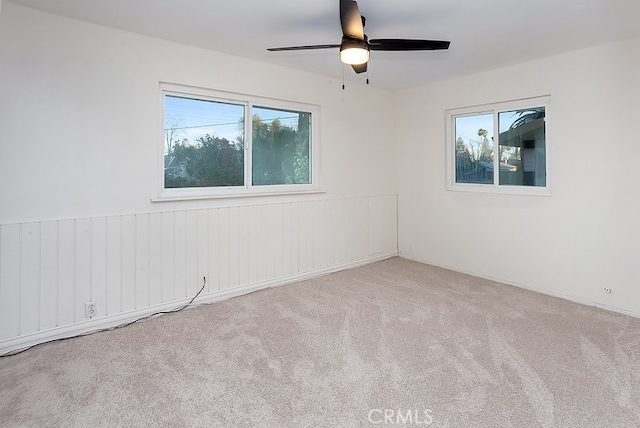 unfurnished room featuring ceiling fan and light colored carpet