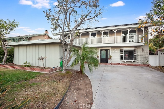 view of front of house featuring a balcony