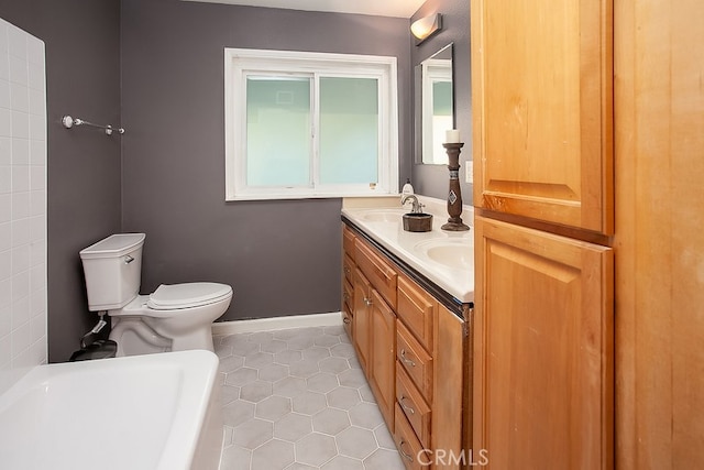 bathroom featuring tile patterned floors, vanity, and toilet