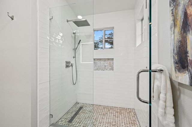 bathroom featuring a shower with shower door