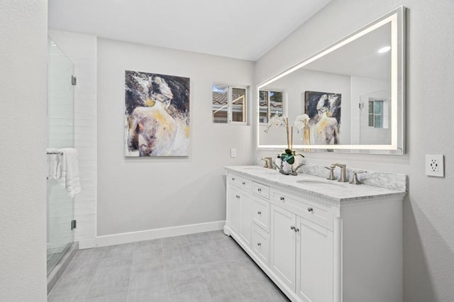 bathroom featuring vanity and a shower with door